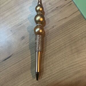 Gold Decorative Pen with Spherical Accents and Textured Design